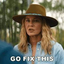 a woman wearing a hat and a blue shirt says go fix this
