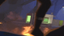 a blurry picture of a person standing in front of a building on fire .