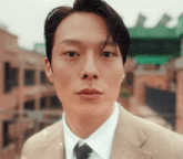 a close up of a man in a suit and tie with the word arimeji on the bottom left