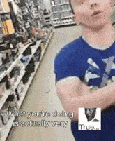 a man in a blue shirt is standing in a store and says what you 're doing is actually very true ...