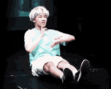 a man is sitting on the floor with his legs crossed