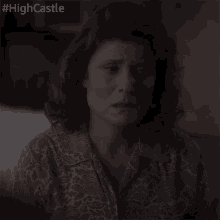 a woman with her eyes closed has #highcastle written on the bottom of her face