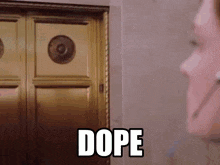 a woman is standing in front of a door with the word dope on it