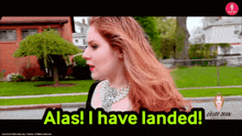 a woman with red hair says alas i have landed on a screen