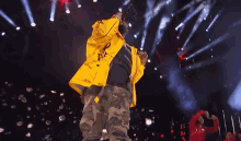 a man wearing a yellow jacket with the word off on it