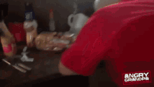 an older man in a red shirt with angry grandpa written on it