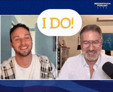 two men are smiling in front of a sign that says i do