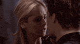 a close up of a man and woman kissing with their eyes closed