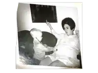 a black and white photo of a baby playing with a stethoscope