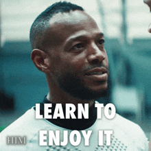 a man with the words learn to enjoy it on his face