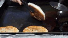 pancakes are being cooked on a tray that says made in animatica on it