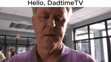 a man in a purple shirt with the words hello dadtime tv on the bottom