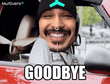 a man in a car says goodbye with a multivers logo in the background