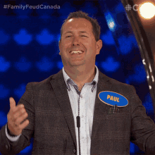 a man in a suit has a name tag that says paul on it