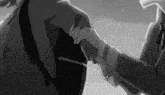 a man in a suit and tie is holding another man 's hand