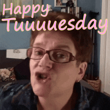 a woman with glasses says happy tuesday in pink