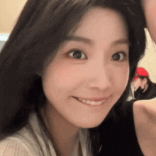 a close up of a woman 's face with a smile