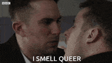 two men are kissing with the words i smell queer written below them