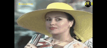 a woman in a yellow hat is holding a book
