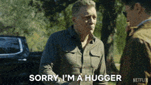 a man says sorry i 'm a hugger in front of a netflix logo