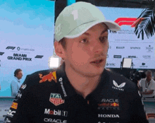 a man wearing a hat and a shirt that says mobil 1