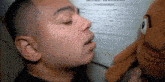 a man is kissing a stuffed animal in front of an employment application form .