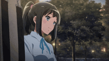 a girl with a ponytail and a blue bow on her neck
