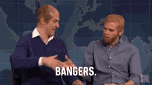 two men are shaking hands and the word bangers is on the screen .