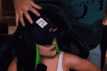 a man in a blue shirt is putting a mask on a girl