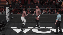 two wrestlers are in a wrestling ring with the word wcw on the floor