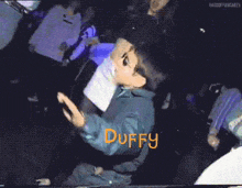 a pixelated image of a person with the name duffy written in orange