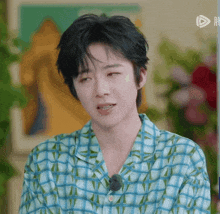 a close up of a person wearing a plaid shirt with chinese writing on it