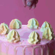 a cake with pink frosting and sprinkles has the word party plus on the bottom