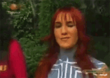 a blurry picture of two women standing next to each other .