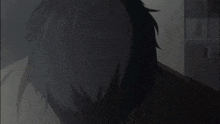 a close up of a man 's face with a tear coming out of his eye .