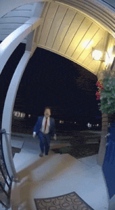 a man in a suit and tie is walking down a set of stairs