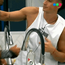 a man wearing a white tank top that says new brand on it