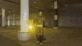 a man in a doctor strange costume is standing in front of a building with a yellow light coming out of it
