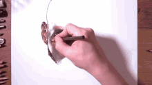 a person is drawing a picture of a man 's head with a pencil