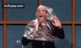 a man is wrapped in plastic wrap and eating a piece of food .