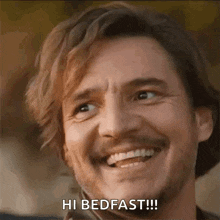 a man with a beard is smiling and says `` hi bedfast '' .