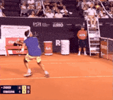 a tennis match is being played and the scoreboard shows that comesana is leading