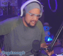 a man wearing headphones and goggles says " i see you "
