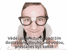 a man wearing glasses and a bandage on his nose is typing on a computer keyboard