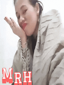 a woman with her hand on her face and the word mrh on the bottom right