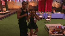 a man and a woman are dancing together in a room