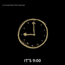 a poster for the la guarimba film festival with a clock on it