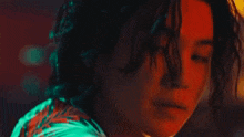 a close up of a person 's face with a red , green and blue light behind them .