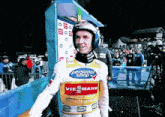 a man wearing a vest that says personal shop viesmann