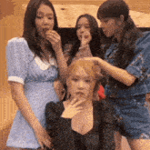 three girls are standing next to each other and one of them is eating something